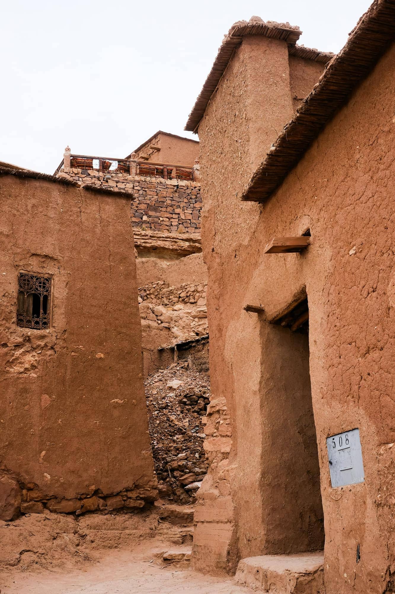 Earth-block buildings settled into a hillside (Reference image, not a CHAYP project)